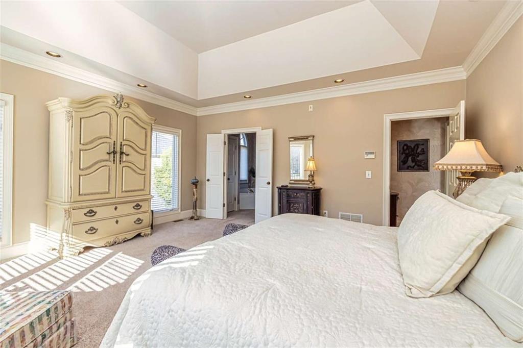 35 Torrey Pines Court Newnan, GA 30265 - Photo 16 of 54 a bedroom with a bed and wooden floor