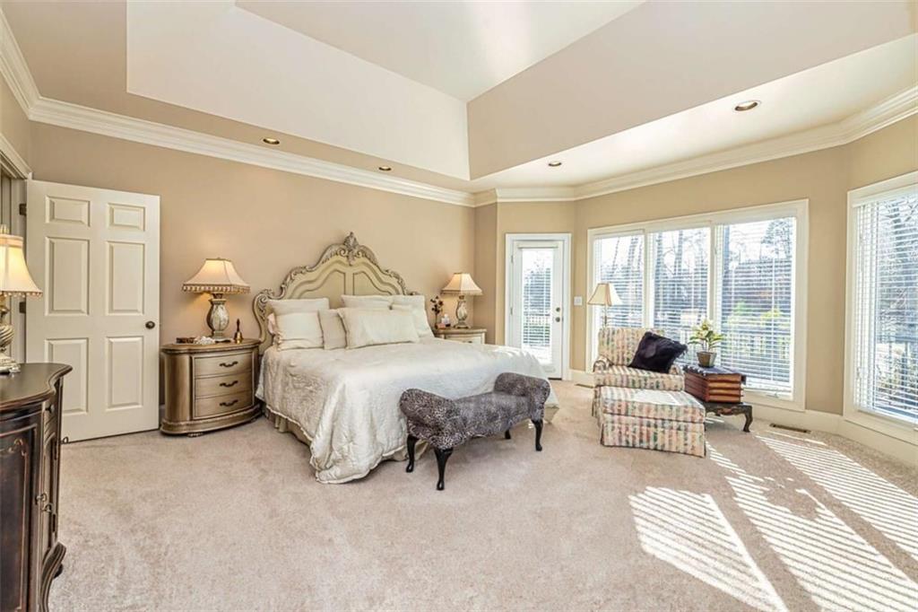 35 Torrey Pines Court Newnan, GA 30265 - Photo 17 of 54 a spacious bedroom with a bed and large windows