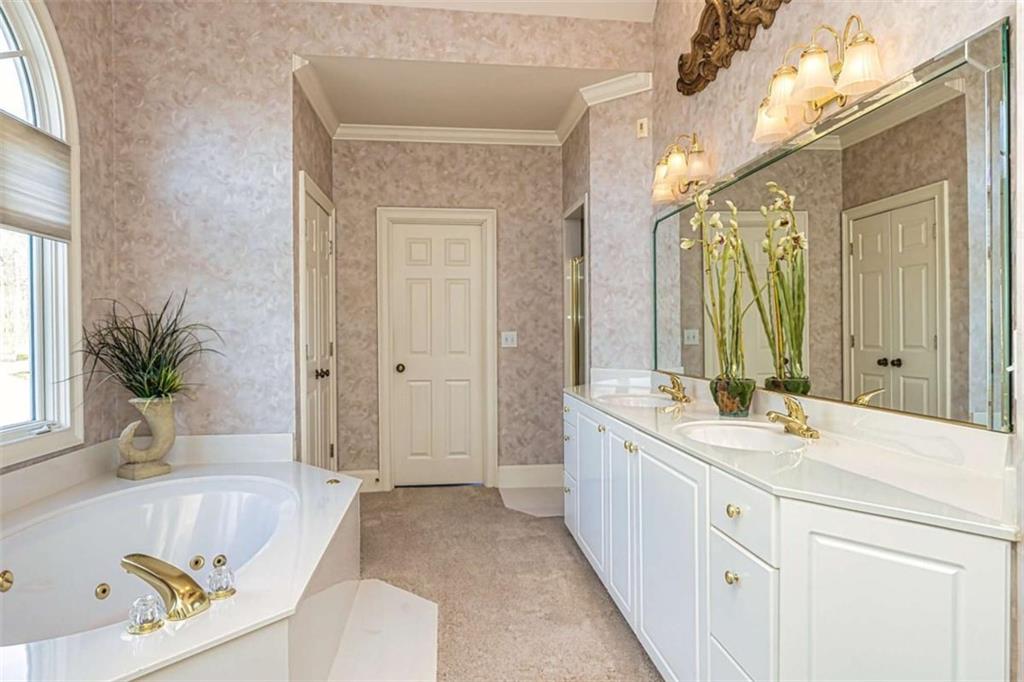 35 Torrey Pines Court Newnan, GA 30265 - Photo 18 of 54 a spacious bathroom with a tub sink and mirror