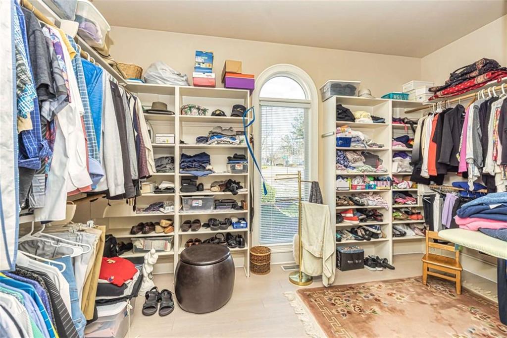 35 Torrey Pines Court Newnan, GA 30265 - Photo 20 of 54 a view of walk in closet with clothes and shoes