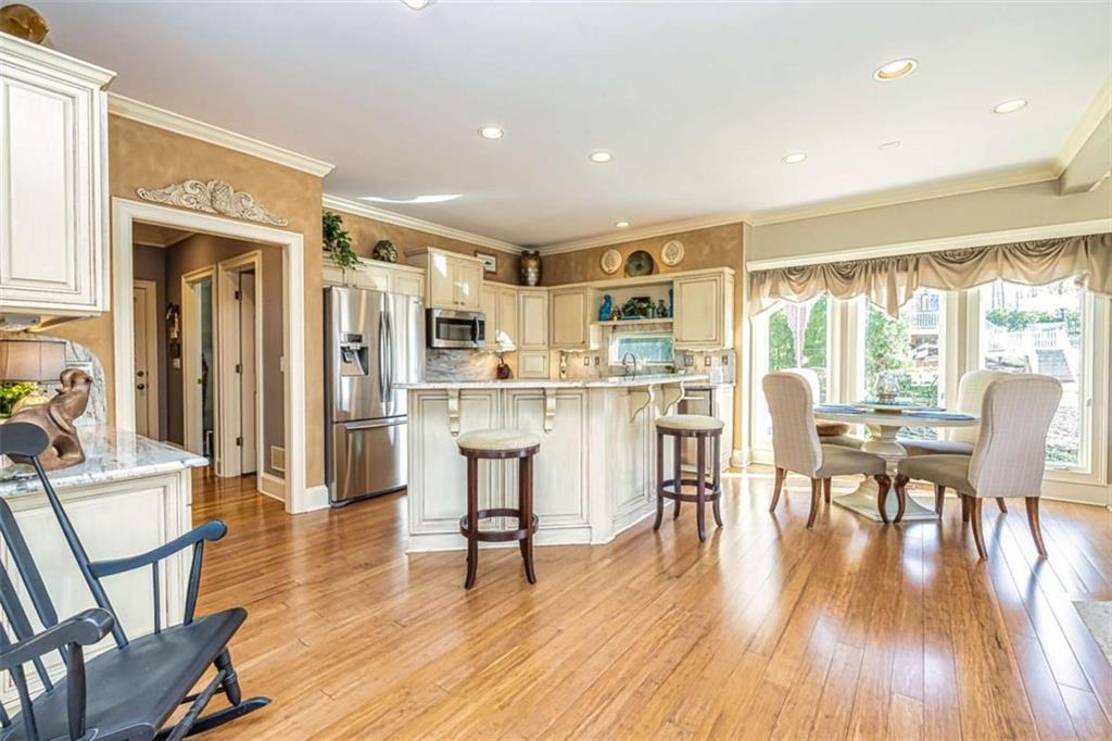 35 Torrey Pines Court Newnan, GA 30265 - Photo 22 of 54 a living room with stainless steel appliances dining table wooden floor and a large window