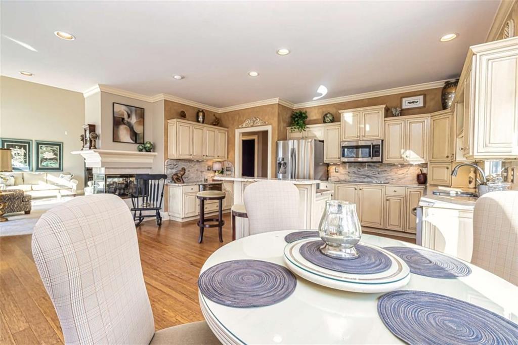 35 Torrey Pines Court Newnan, GA 30265 - Photo 23 of 54 a kitchen with a dining table and chairs