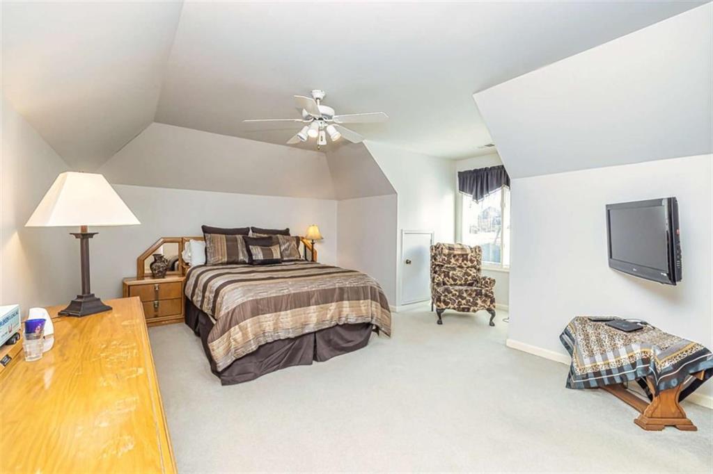 35 Torrey Pines Court Newnan, GA 30265 - Photo 31 of 54 a spacious bedroom with a bed and a couch