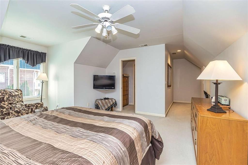 35 Torrey Pines Court Newnan, GA 30265 - Photo 32 of 54 a bedroom with a bed and a chandelier