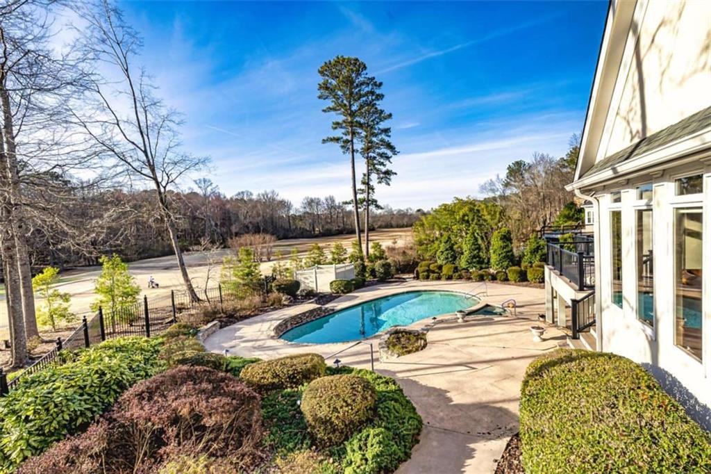 35 Torrey Pines Court Newnan, GA 30265 - Photo 47 of 54 a view of a swimming pool with a patio
