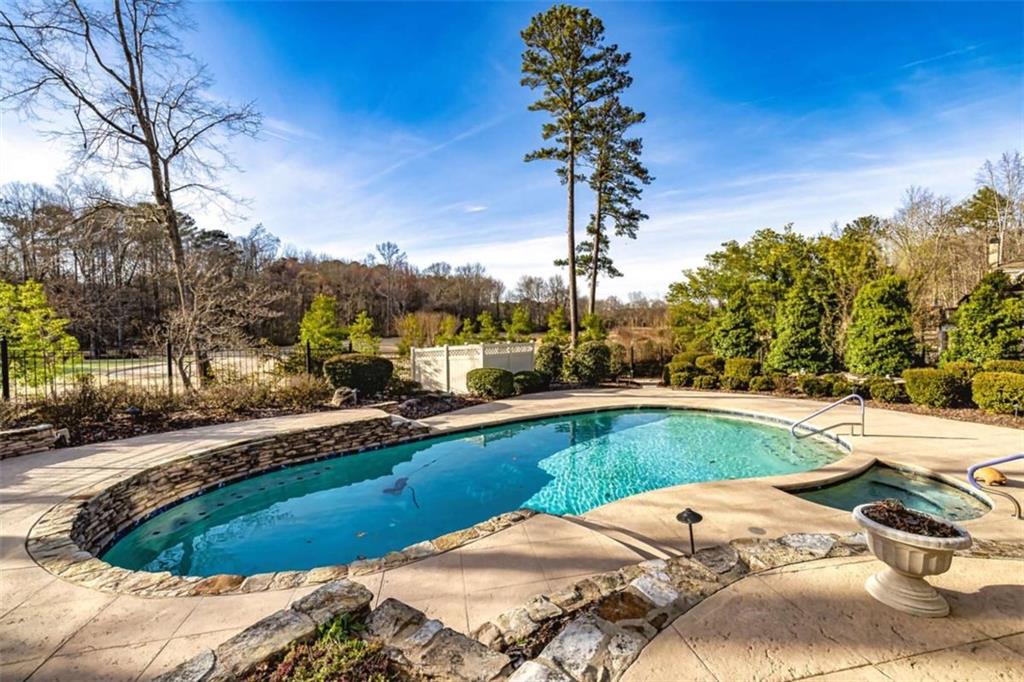 35 Torrey Pines Court Newnan, GA 30265 - Photo 53 of 54 a view of a swimming pool with a patio and a yard