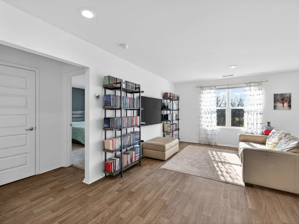 a living room with furniture and a book shelf