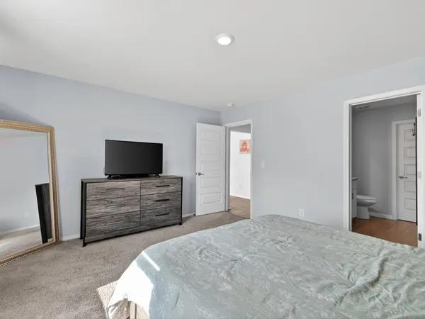 a bedroom with a bed and flat screen tv