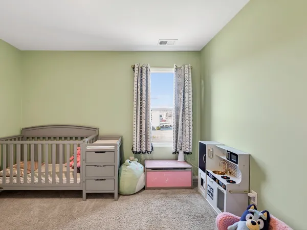 a bedroom with furniture and a window