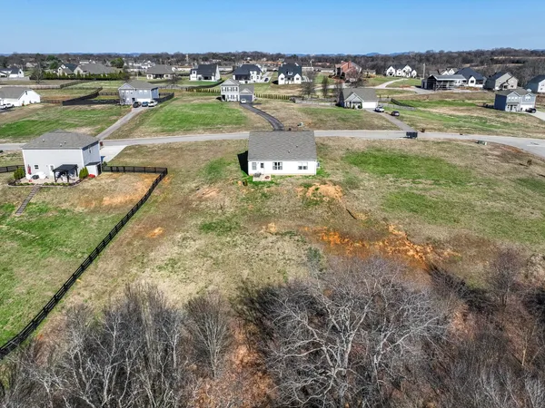 an aerial view of a houses with outdoor space and parking