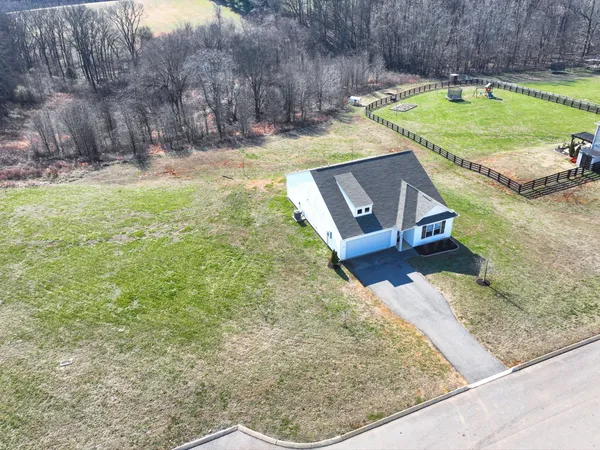 a view of a backyard with wooden fence