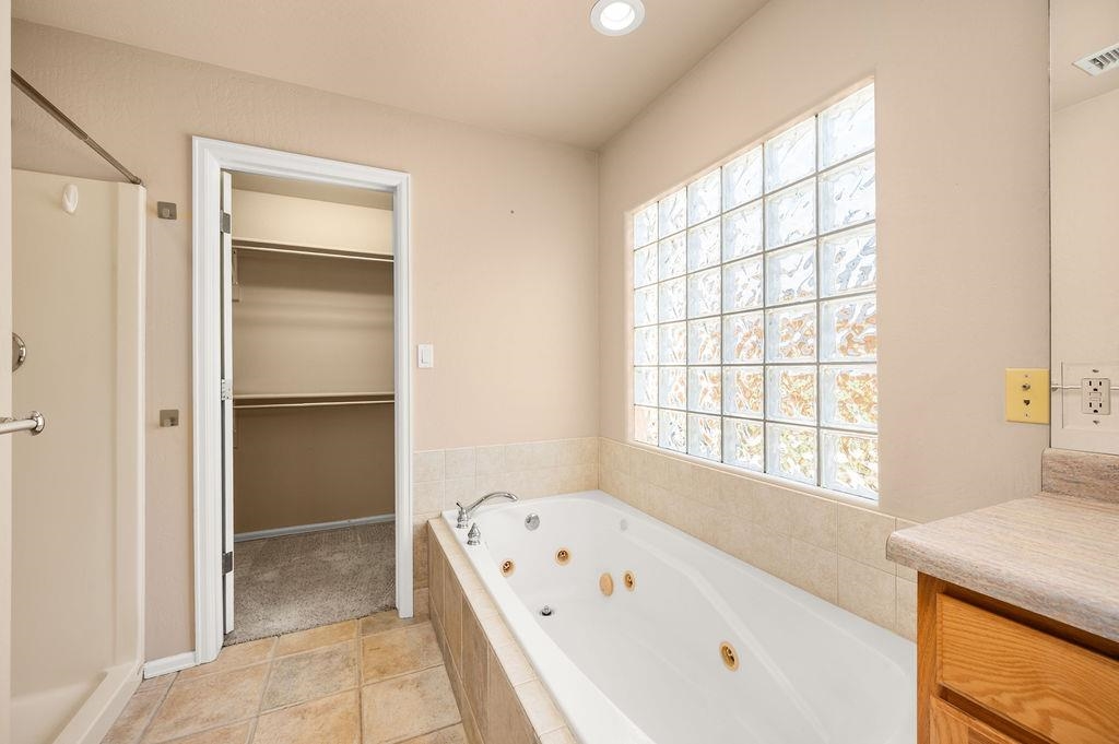 710 Comstock Drive Fruita, CO 81521 - Photo 13 of 25 a bathroom with a bathtub and a shower