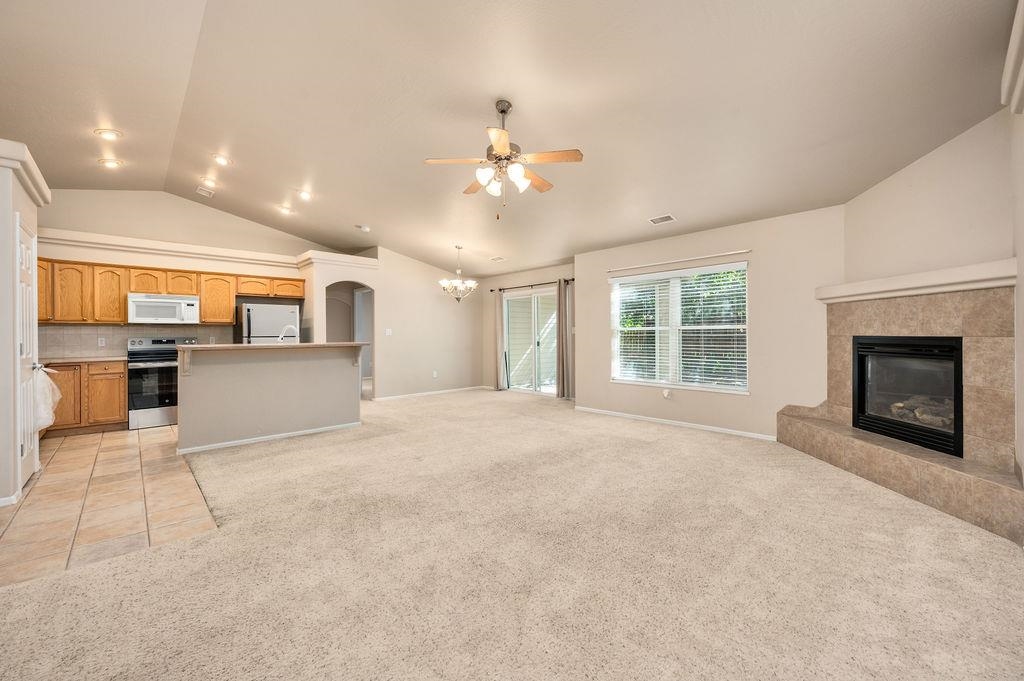 710 Comstock Drive Fruita, CO 81521 - Photo 14 of 25 a view of an empty room with a fireplace and a window