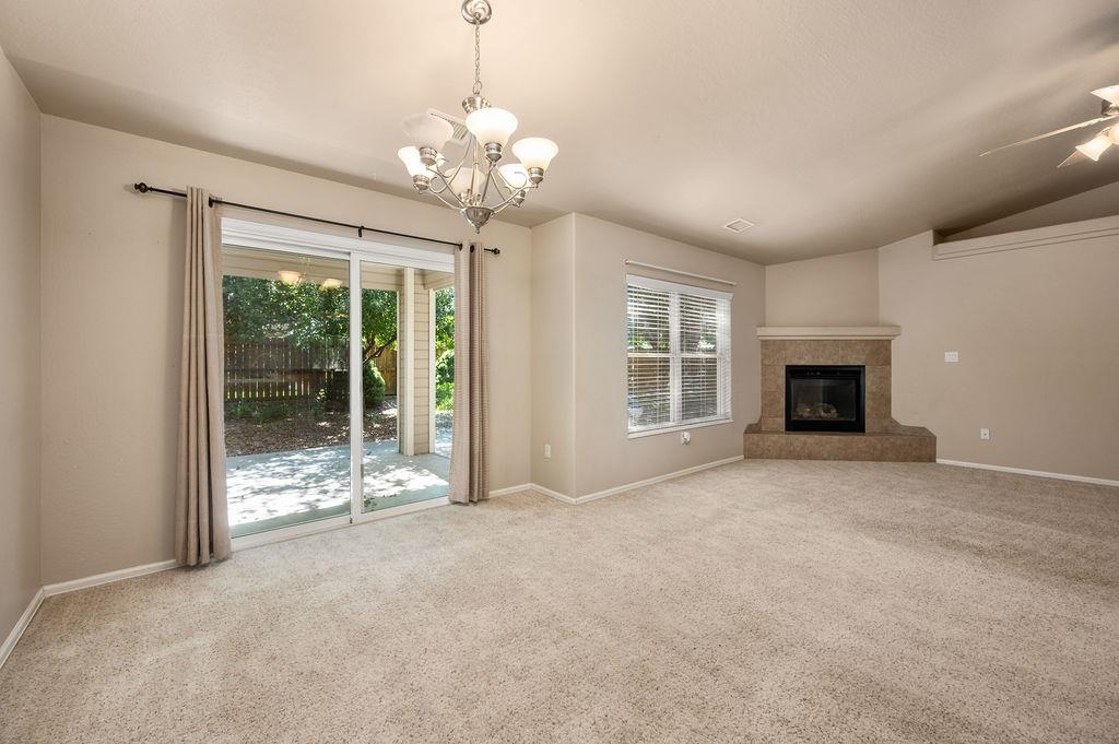 710 Comstock Drive Fruita, CO 81521 - Photo 15 of 25 a view of an empty room with fireplace and a window