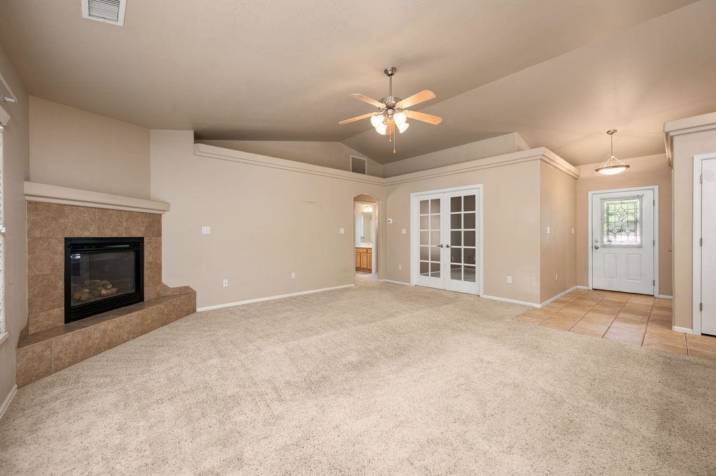 710 Comstock Drive Fruita, CO 81521 - Photo 16 of 25 a view of an empty room with a fireplace and a ceiling fan