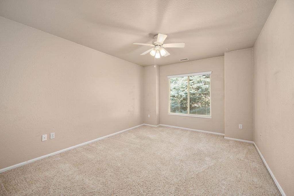 710 Comstock Drive Fruita, CO 81521 - Photo 19 of 25 an empty room with a window and a fan