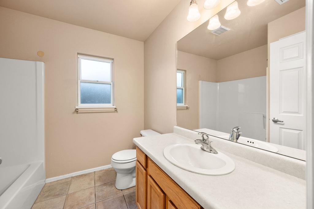 710 Comstock Drive Fruita, CO 81521 - Photo 20 of 25 a bathroom with a sink a toilet and mirror