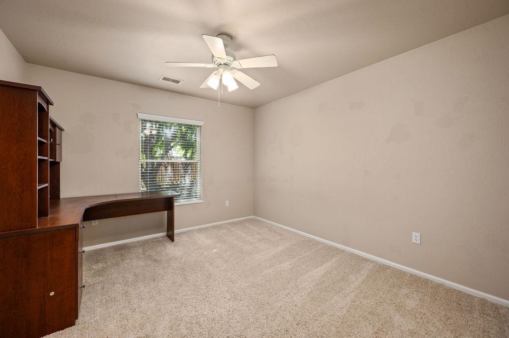 710 Comstock Drive Fruita, CO 81521 - Photo 21 of 25 an empty room with windows and fan