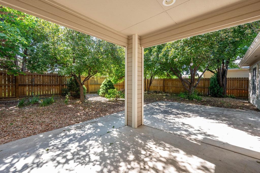 710 Comstock Drive Fruita, CO 81521 - Photo 23 of 25 a view of a yard with a large tree and wooden fence