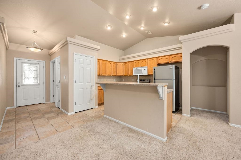 710 Comstock Drive Fruita, CO 81521 - Photo 4 of 25 a kitchen with stainless steel appliances granite countertop a refrigerator and a sink
