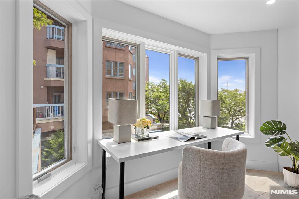 302 Smith Court Edgewater, NJ 07020 - Photo 19 of 34 a living room with furniture and a potted plant
