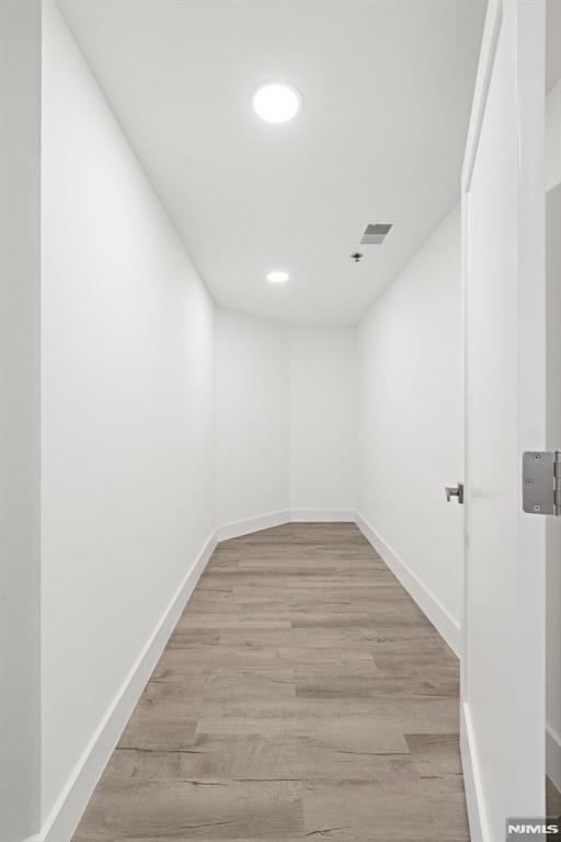 302 Smith Court Edgewater, NJ 07020 - Photo 22 of 34 a view of empty room with wooden floor