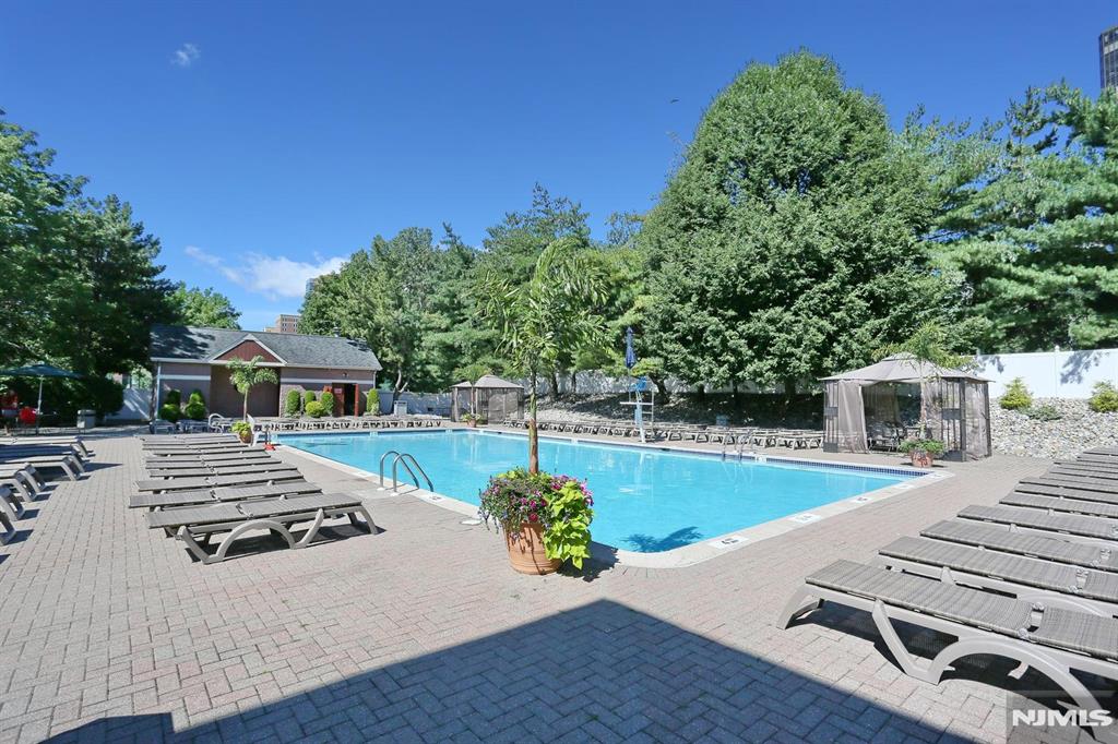 302 Smith Court Edgewater, NJ 07020 - Photo 29 of 34 a view of a patio with couches table and chairs with wooden fence and plants
