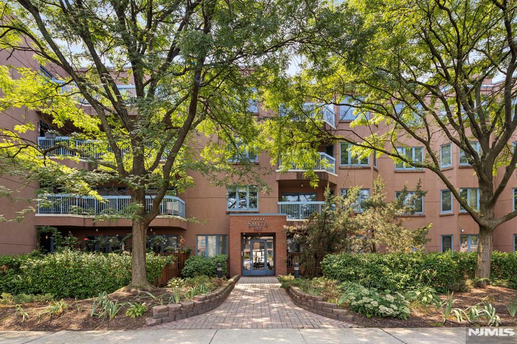 302 Smith Court Edgewater, NJ 07020 - Photo 34 of 34 front view of a house with a tree