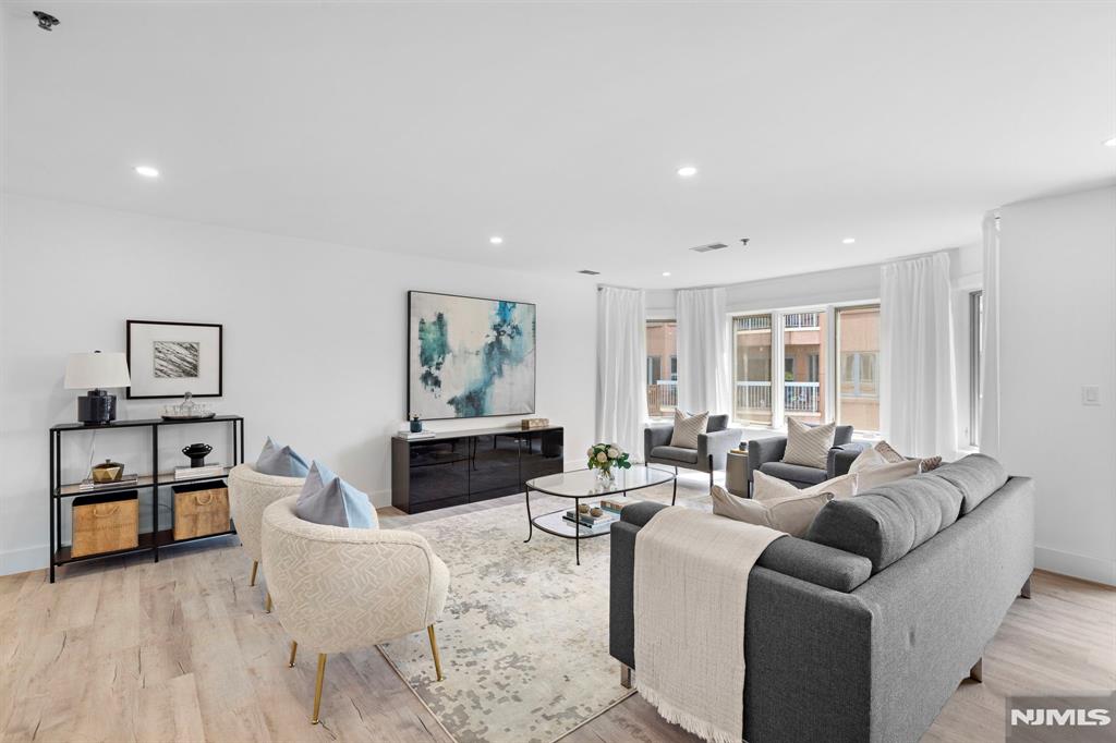 302 Smith Court Edgewater, NJ 07020 - Photo 7 of 34 a living room with furniture and a large window