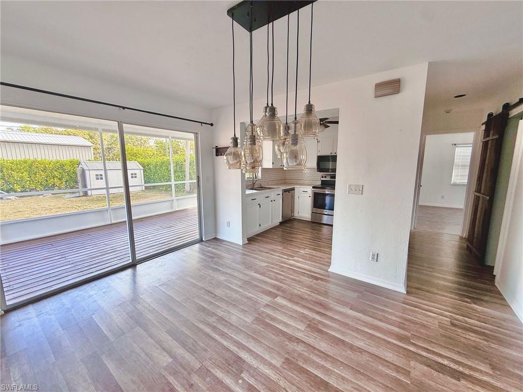 4211 Cindy Avenue Naples, FL 34112 - Photo 18 of 26 a view of open kitchen with wooden floor and outdoor space