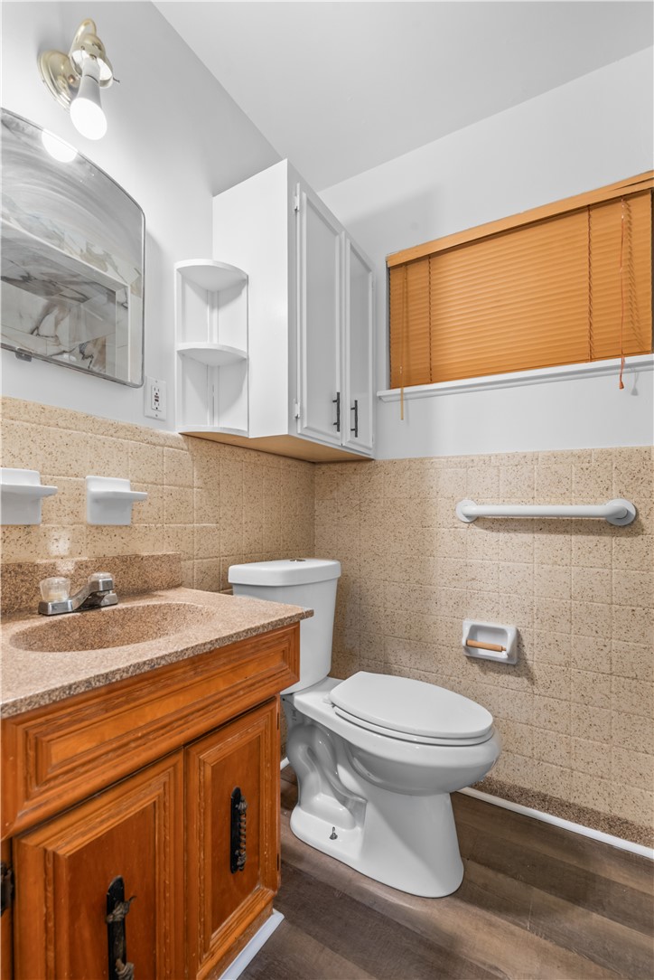 4402 Dolphin Place Corpus Christi, TX 78411 - Photo 19 of 27 a bathroom with a sink a toilet and mirror