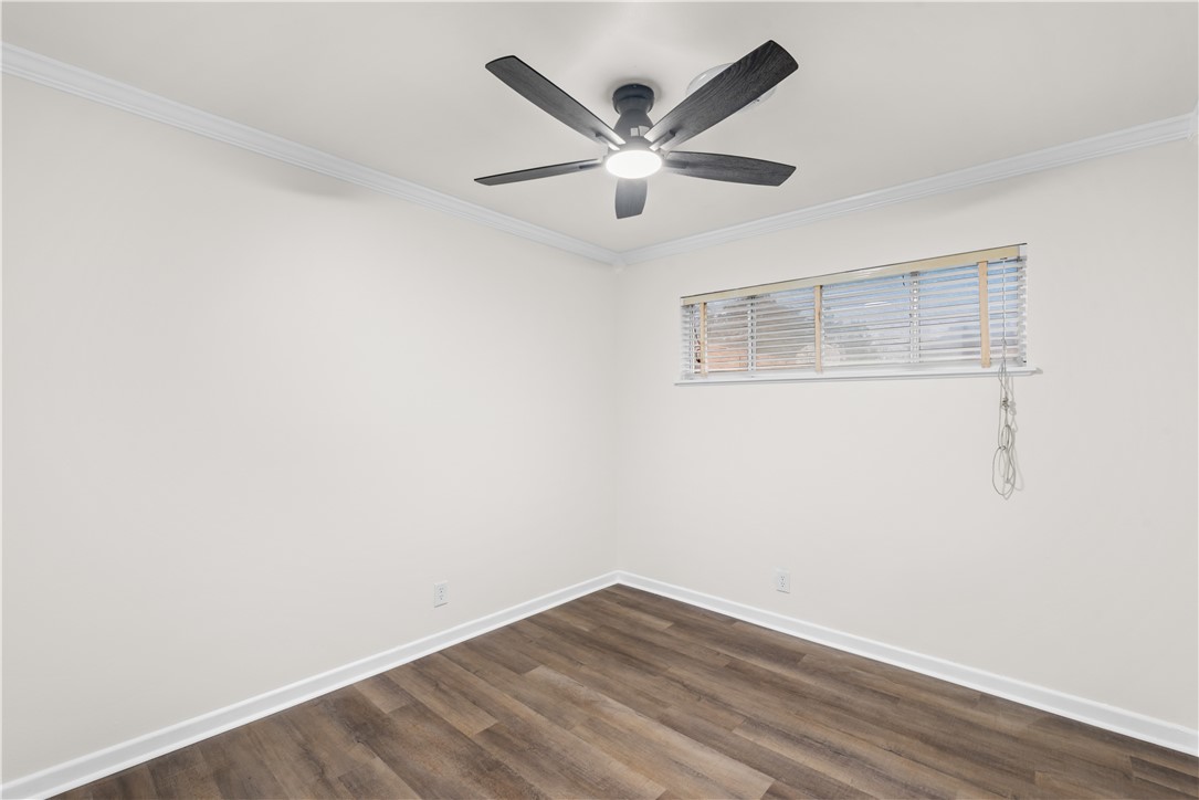 4402 Dolphin Place Corpus Christi, TX 78411 - Photo 22 of 27 an empty room with wooden floor and ceiling fan