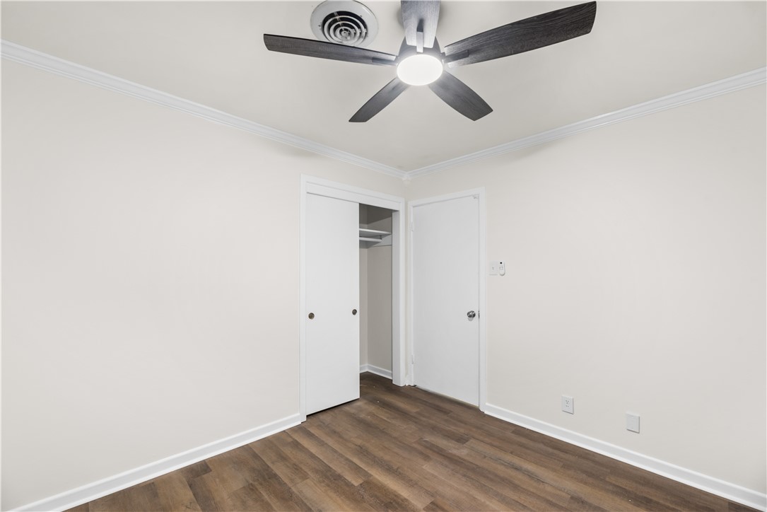 4402 Dolphin Place Corpus Christi, TX 78411 - Photo 23 of 27 an empty room with a ceiling fan and wooden floor