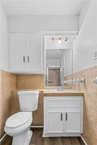 a bathroom with a toilet sink and mirror
