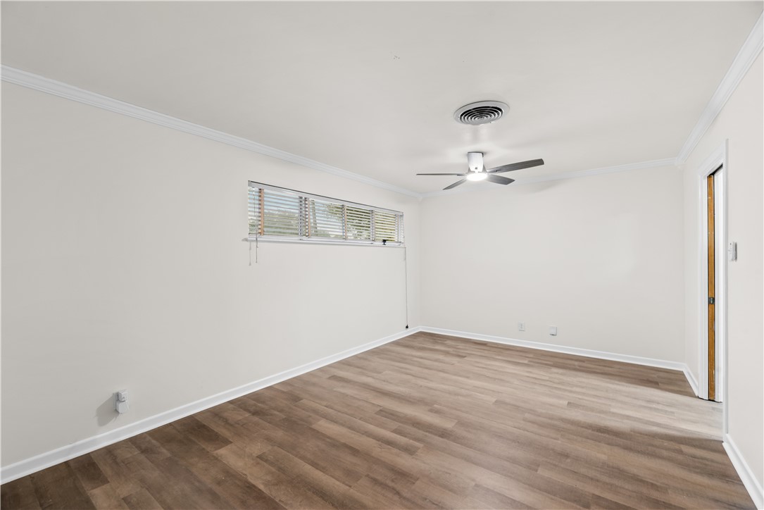 4402 Dolphin Place Corpus Christi, TX 78411 - Photo 5 of 27 a view of a room with wooden floor and ceiling fan