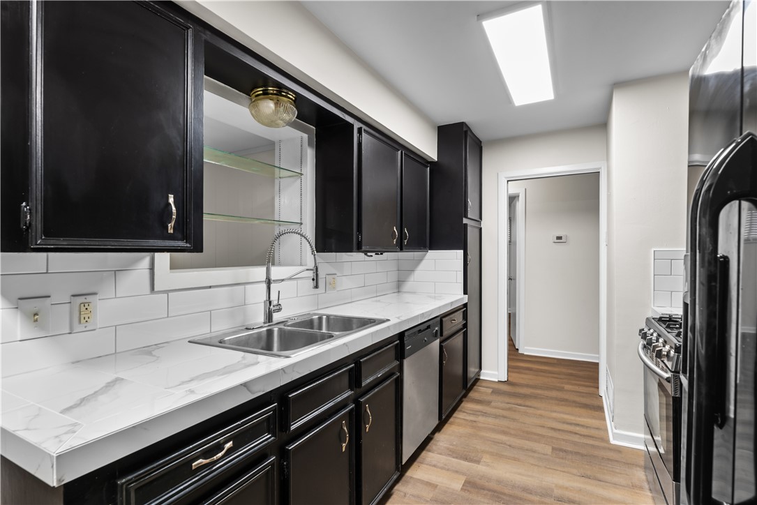4402 Dolphin Place Corpus Christi, TX 78411 - Photo 7 of 27 a kitchen with a sink and refrigerator