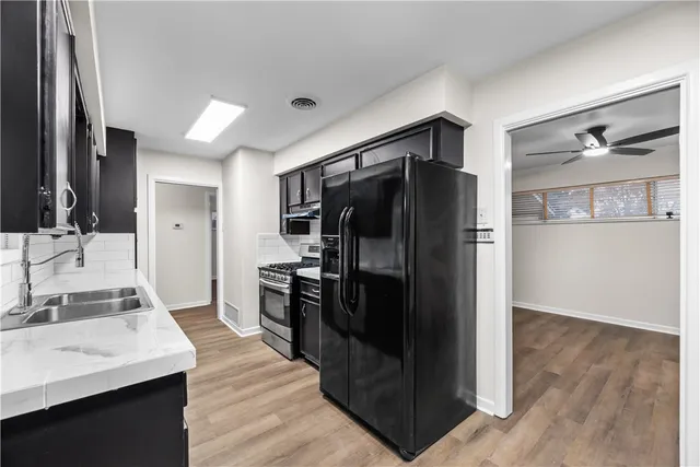 a kitchen with stainless steel appliances a refrigerator and a sink