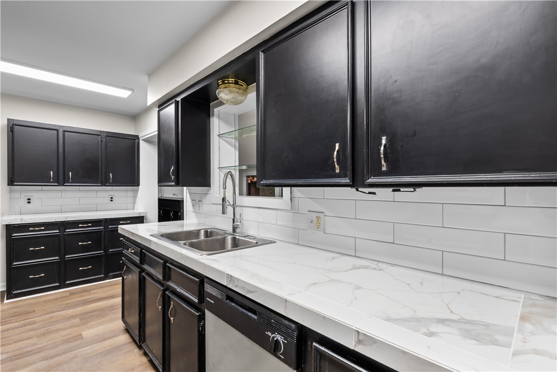 4402 Dolphin Place Corpus Christi, TX 78411 - Photo 10 of 27 a kitchen with a sink and cabinets