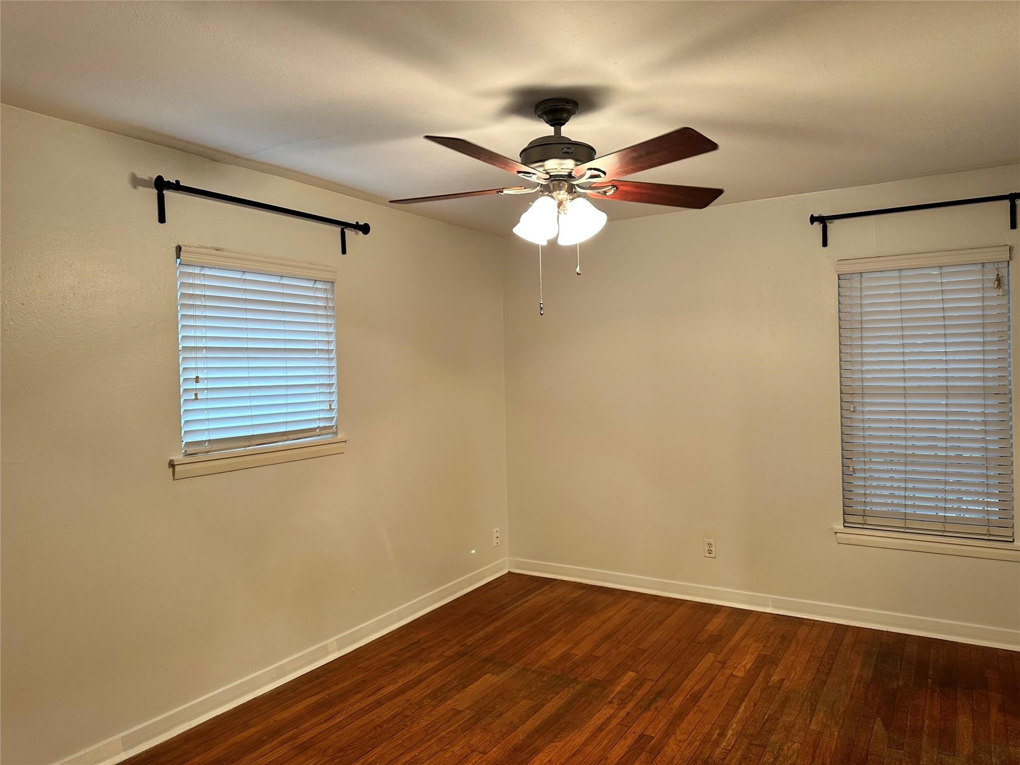 2022 Branard Street, Unit 5 Houston, TX 77098 - Photo 11 of 16 a view of a big room with wooden floor and windows