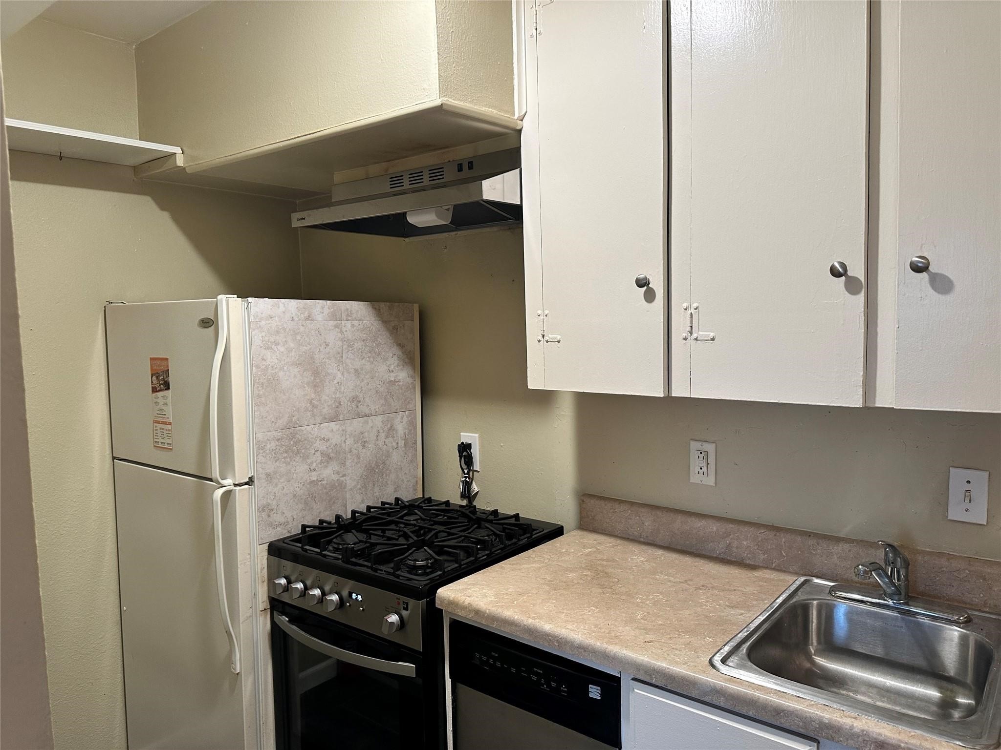 2022 Branard Street, Unit 5 Houston, TX 77098 - Photo 13 of 16 a kitchen with a refrigerator and a sink
