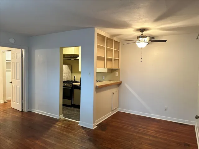 an empty room with wooden floor and a window