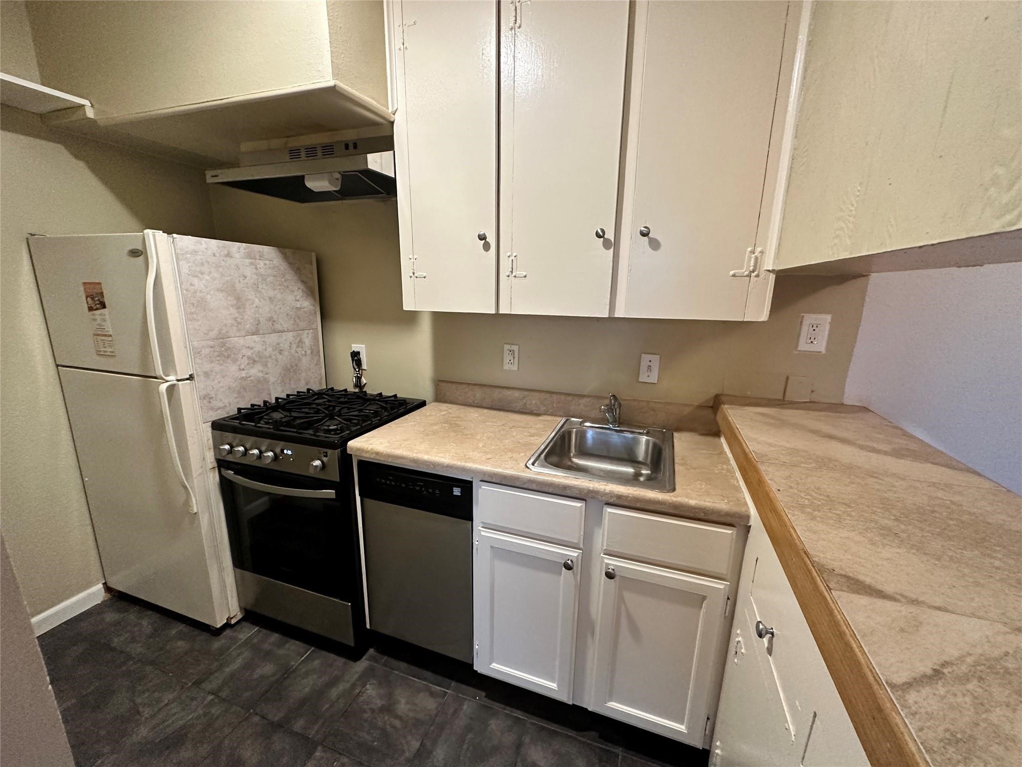 2022 Branard Street, Unit 5 Houston, TX 77098 - Photo 8 of 16 a kitchen with a stove sink and cabinets
