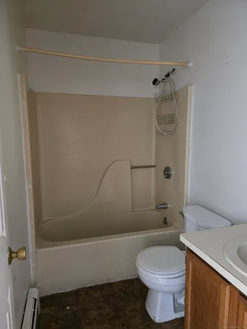a bathroom with a toilet and shower