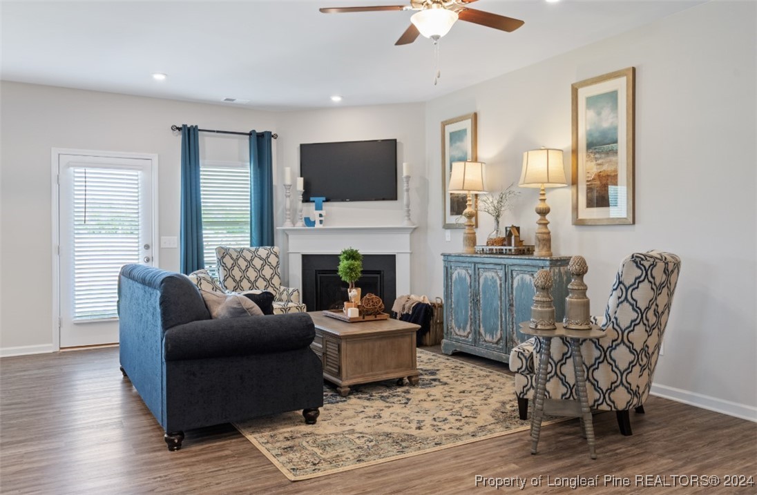 1594 Old Barn Road Fayetteville, NC 28312 - Photo 14 of 18 a living room with furniture a flat screen tv and a fireplace