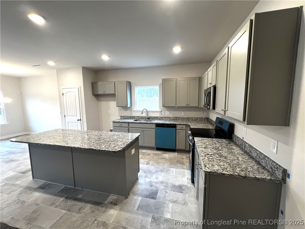 1594 Old Barn Road Fayetteville, NC 28312 - Photo 2 of 18 a kitchen with kitchen island granite countertop a sink counter top space appliances and cabinets