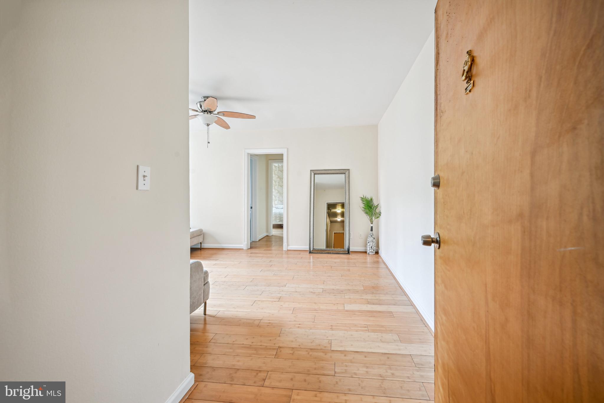 939 Longfellow Street Northwest, Unit 205 Washington, DC 20011 - Photo 1 of 16 a view of a hallway with wooden floor and a bathroom
