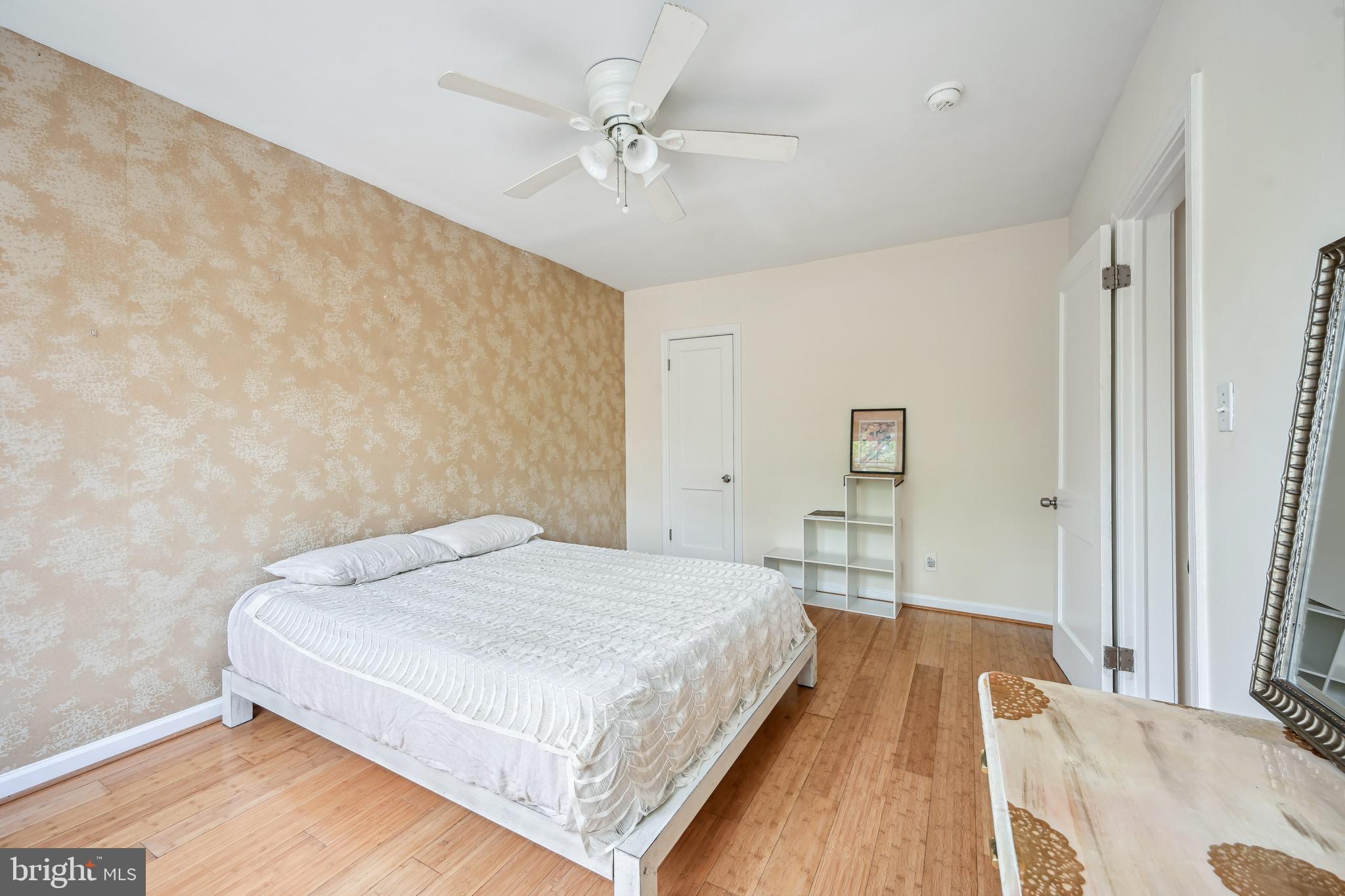 939 Longfellow Street Northwest, Unit 205 Washington, DC 20011 - Photo 12 of 16 a spacious bedroom with a bed and a chandelier
