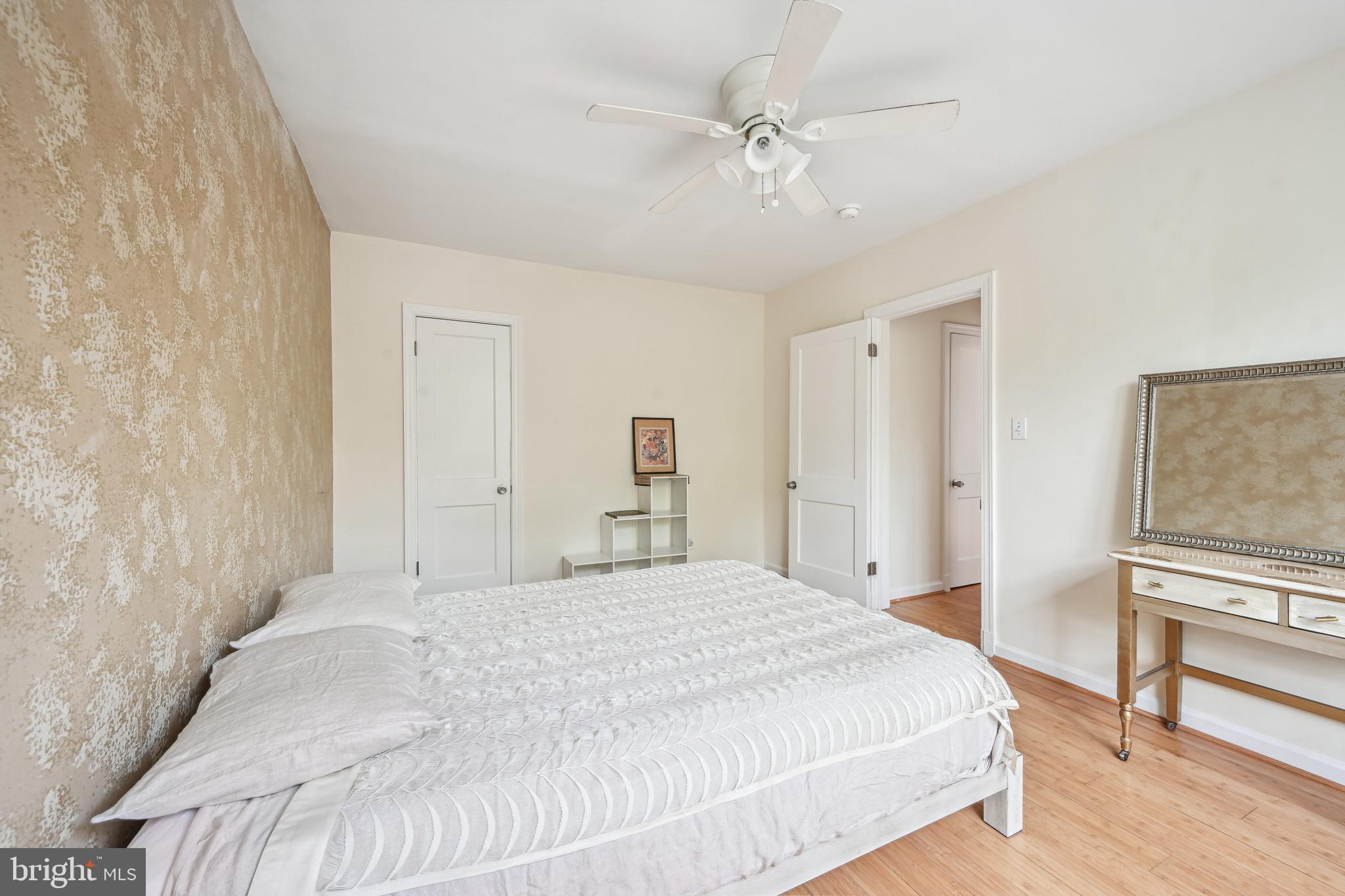 939 Longfellow Street Northwest, Unit 205 Washington, DC 20011 - Photo 13 of 16 a spacious bedroom with a bed and a chandelier