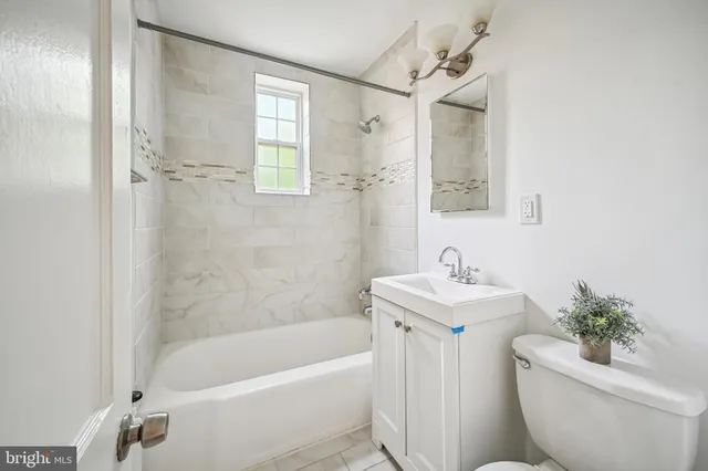 a bath room with a toilet sink and shower