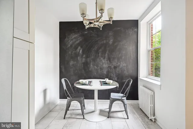 a view of a dining room with furniture and a window